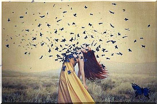 Woman with birds flying around her.