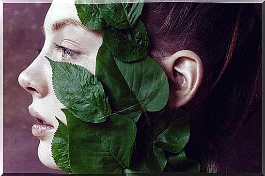 woman with leaves on her face