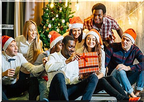 Young people opening presents at Christmas