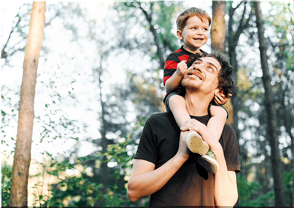 father with son on shoulders