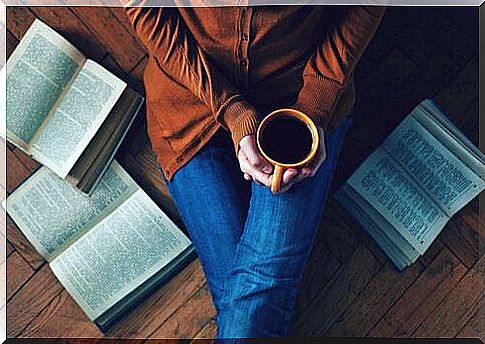 woman-having-coffee-sitting-on-the-floor-with-book