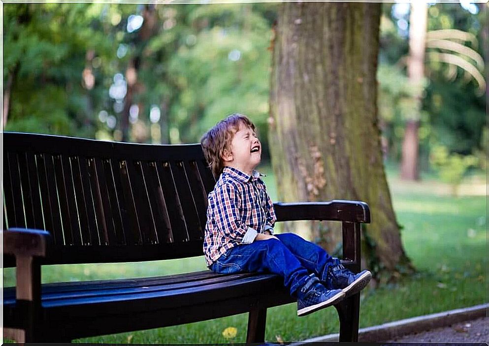 boy having a tantrum in the park