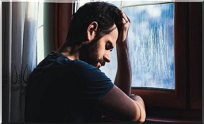 upset man in front of window