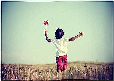 child playing with pinwheel