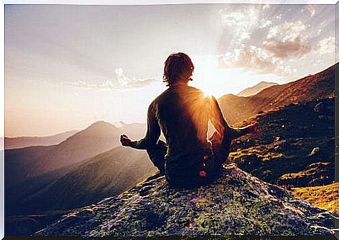 man meditating in the mountains