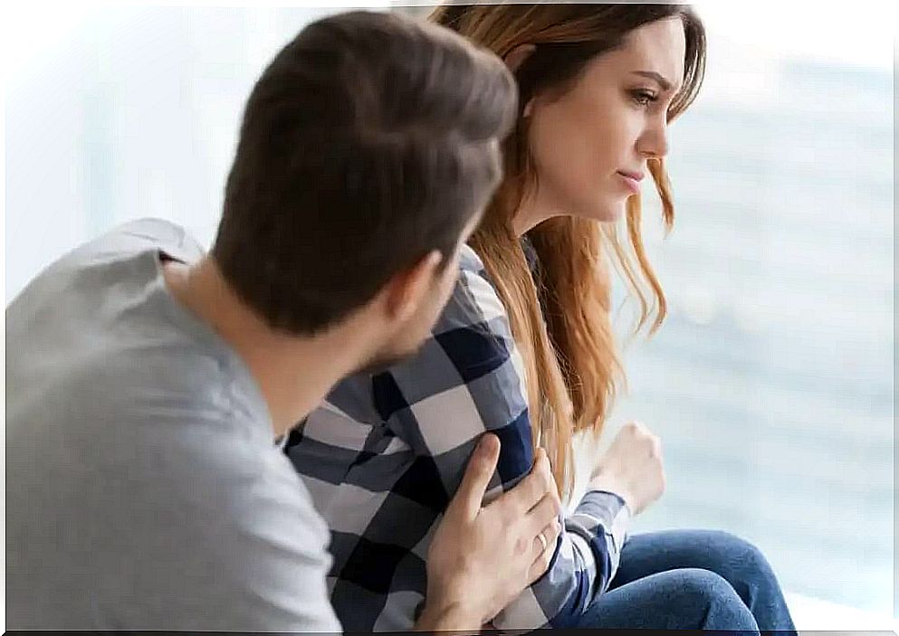 man comforting sad woman