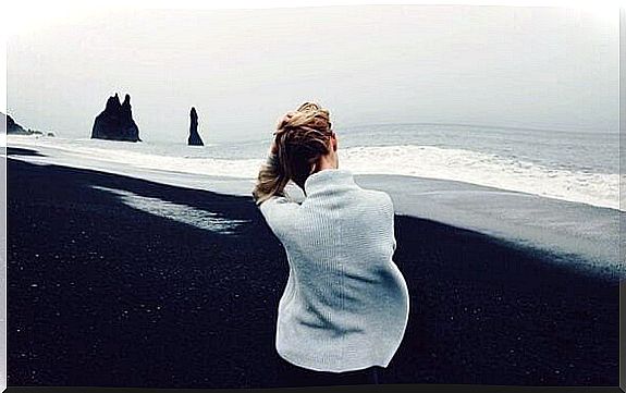 woman on black sand beach