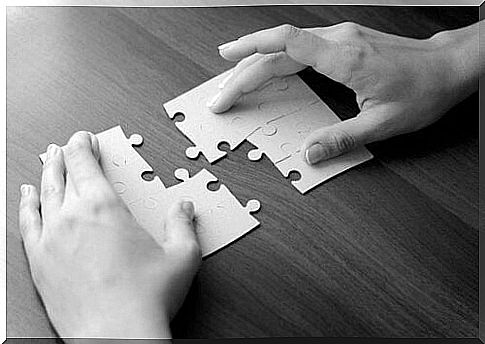 hands assembling puzzles