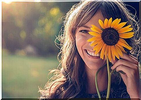 Woman with sunflower on her face